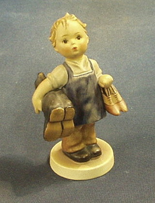 A Goebal figure of a standing girl in Wellington boots and shoes, 6" (f and r)