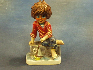 A Goebal figure of a seated boy with model yacht, the base marked Mic10 9"