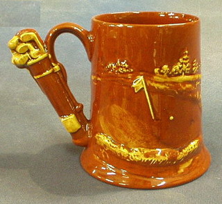 A Dartmouth pottery mug decorated a golfer with clubs for handle 5"