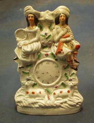A 19th Century flat back Staffordshire figure in the form of clock supported by 2 figures 10" (f and r)