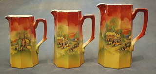 A set of 3 1930's octagonal shaped pottery jugs decorated Romany caravans
