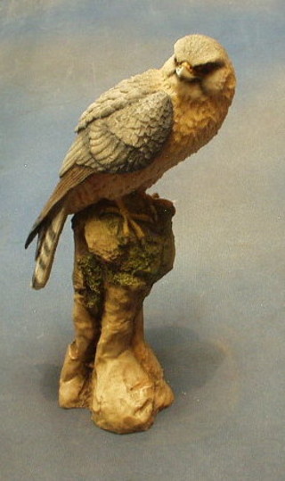 A resin figure of a bird of prey on a rocky outcrop 12"
