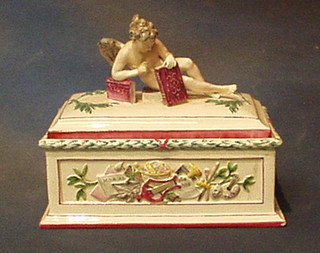 A 19th Century Continental porcelain trinket box, the lid decorated a seated learned cherub 10" (f and r)