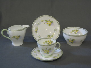 A 21 piece Shelley floral pattern tea service comprising twin handled bread plate, 6 tea plates, cream jug, sugar bowl, 6 cups and saucers (1 cup cracked), the base marked 125 14, painted with primroses