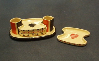 An Art Deco Royal Doulton ashtray and match holder  stand decorated playing cards, the stand fitted 2 match holders and 4 shaped ashtrays, the base marked Royal Doulton RD 7633 54