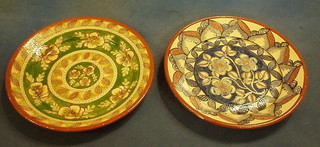 2 circular terracotta chargers with floral decoration marked Anamakia, 14"