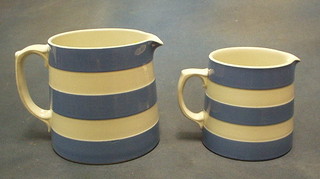 2 graduated T G Greener Cornish kitchen ware blue and white striped jugs with green shield mark to base