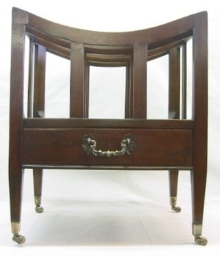 A 19th Century mahogany 3 section Canterbury, the base fitted a drawer and raised on square tapering supports ending in brass caps and castors 19"