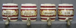 4 pottery red and gilt banded spirit barrels "Gin", "Brandy", "Irish Whiskey" and "Scots Whiskey" (chipped to inside lid)