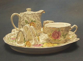 A Thomas Kent floral patterned "Tea For One" cabaret service comprising twin handled tea tray, teapot, tea cup sugar bowl, cream jug and toast rack