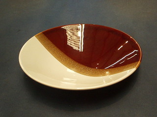 A 1960's Poole pottery brown and white glazed bowl, the base with Dolphin mark 11"