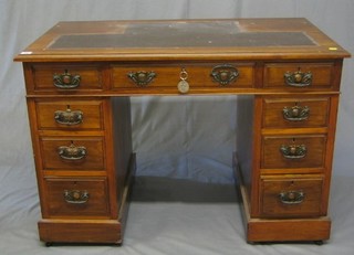 A Victorian walnutwood kneehole pedestal desk with inset tooled leather writing surface, fitted 9 drawers 43"