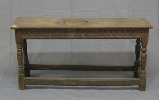 An antique carved oak joyned stool, on turned and block supports 44"