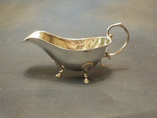 A Continental silver sauce boat with C scroll handle, raised on hoof supports 3 ozs