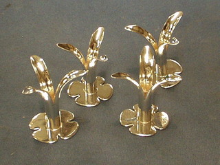 4 Continental silver taper sticks in the form of flower heads, the bases marked OSP 40, 4 ozs