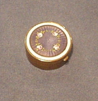 A gilt metal and enamel circular rouge pot