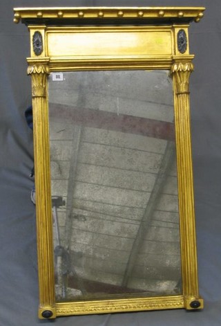 A Regency rectangular plate wall mirror contained in a gilt frame with moulded cornice with ball stud decoration, supported by a pair of reeded columns 37"