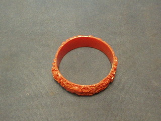 A circular carved "coral" bangle
