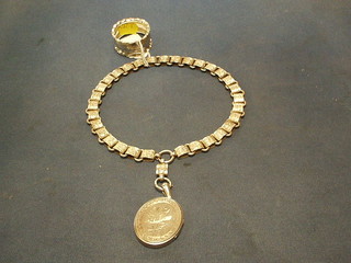 A silver coloured necklet hung a "silver" locket together with a silver napkin ring 