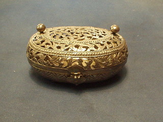 An oval pierced Eastern "silver" box with hinged lid  7"