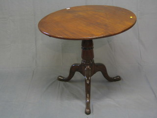 A 19th Century circular mahogany snap top tea table raised on a gun barrel and tripod column 33"
