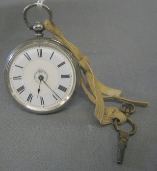 A silver open faced pocket watch with enamelled dial contained in an engraved silver case