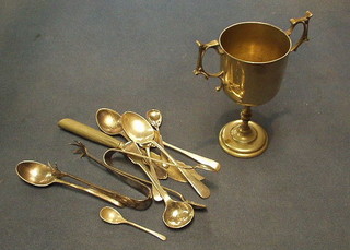 A silver plated twin handled trophy cup, 3 silver condiment spoons, 3 silver teaspoons, a silver spoon and other flatware