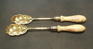 A pair of silver plated salad servers with porcelain handles