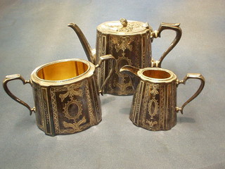 An engraved Britannia metal 3 piece tea service with teapot, cream jug and twin handled sugar bowl