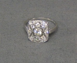 A lady's 18ct white gold dress ring set a circular cut diamond surrounded by numerous diamonds (0.63 ct)