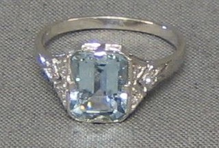 A lady's 18ct white gold dress ring set a rectangular cut aquamarine supported by 6 diamonds