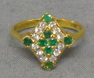 A lady's 18ct gold dress ring of marquise form set 8 emeralds supported by 12 diamonds