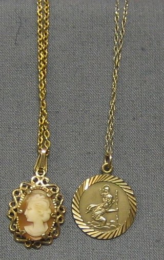 A 9ct gold St Christopher medal hung on a fine gold chain and a shell carved cameo pendant hung on a fine gold chain (2)