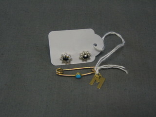 An Edwardian gold bar brooch set a turquoise and a gold letter M and a pair of "sapphire and diamond" ear studs