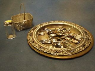 A miniature porcelain heart shaped scent bottle, a silver plated bread board frame, a cut glass pin jar with silver lid and a small collection of various souvenir spoons