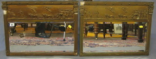 A pair of 19th Century rectangular bevelled plate chimney mirrors with frieze decorated chariots contained in gilt frames 22"