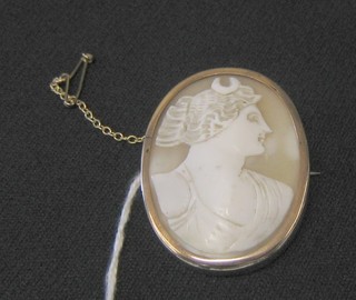 A 19th Century shell carved cameo portrait brooch of Diana contained in a gilt metal mount