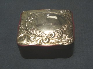 A modern shaped leather trinket box with embossed silver lid 4"