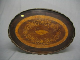 A 19th Century oval mahogany tea tray with wavy border, inlaid floral decoration and crossbanded, 28"