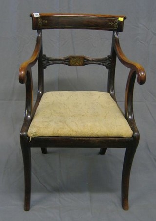 A Regency rosewood and simulated rosewood inlaid brass bar back desk chair, with upholstered drop in seat, on sabre supports