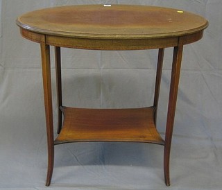 An Edwardian oval inlaid mahogany 2 tier occasional table raised on tapered supports 30"