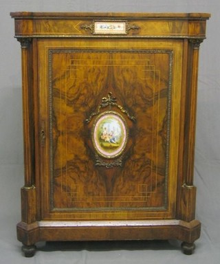 A Victorian inlaid figured walnutwood pier cabinet supported by a pair of Corinthian columns with gilt ormolu mounts, having pink "Sevres" porcelain plaque to the door 29"