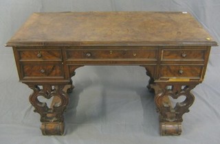 A 19th Century Continental figured walnutwood library writing table, fitted 1 long and 4 long drawers, raised on pierced standard end supports 48"