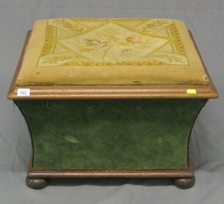 A Victorian mahogany framed footstool of waisted form, raised on bun feet 22"