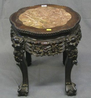 A 19th Century circular Oriental Padouk wood jardiniere stand with pink veined marble top, raised on hoof supports 17"