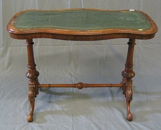 A Victorian walnutwood stretcher table of serpentine outline, the top with inset tooled leather writing surface, raised on florette carved columns united by an H framed stretcher 36"