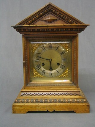 A 19th Century Continental 8 day striking bracket clock with silvered dial Roman numerals contained in a carved walnutwood case (wormed)