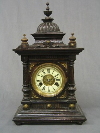 A Victorian 8 day striking bracket clock (The Greenwich Clock by W E Watts) contained in a carved walnutwood case