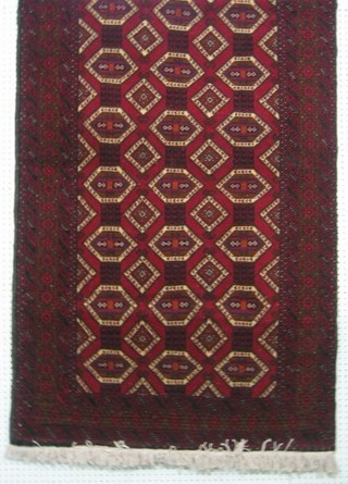 A contemporary Persian Meshed rug with red ground and numerous octagons 71" x 41"