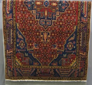 A contemporary Hamadan rug with central medallion within multi-row borders 103" x 57"